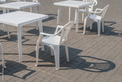 white plastic chairs and tables  background