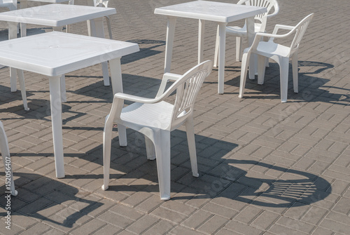 white plastic chairs and tables, background