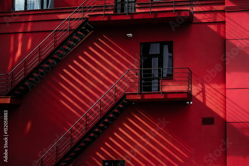 red building with stairs and shadows