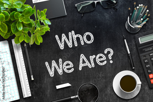 Who We Are. Business Concept Handwritten on Black Chalkboard. Top View Composition with Chalkboard and Office Supplies. 3d Rendering. Toned Image.