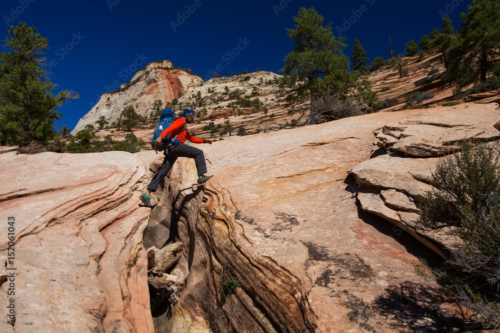 Fototapeta premium A men is hiking in Zion National Par, Utah, USA