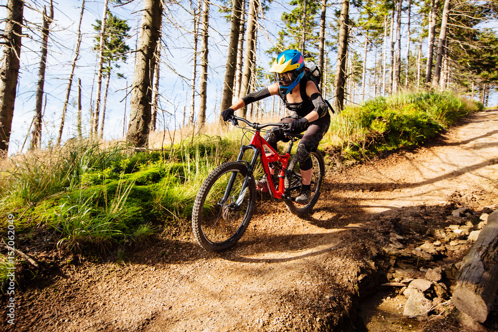 Picture of young woman riding mtb mountain bike, downhill