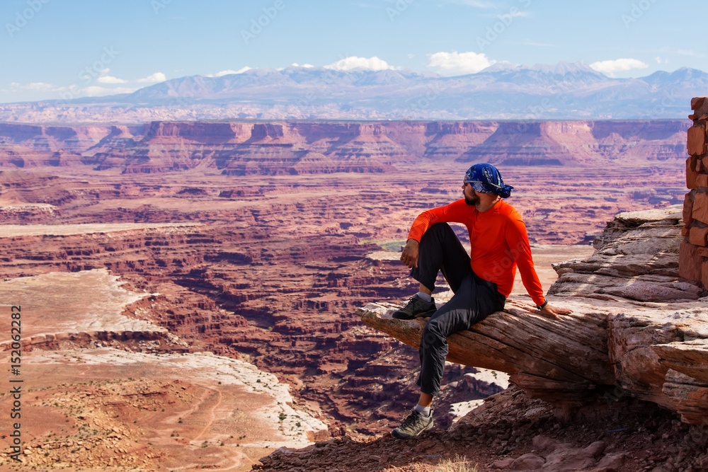 Fototapeta premium Hiker rests in Canyonlands National park in Utah, USA