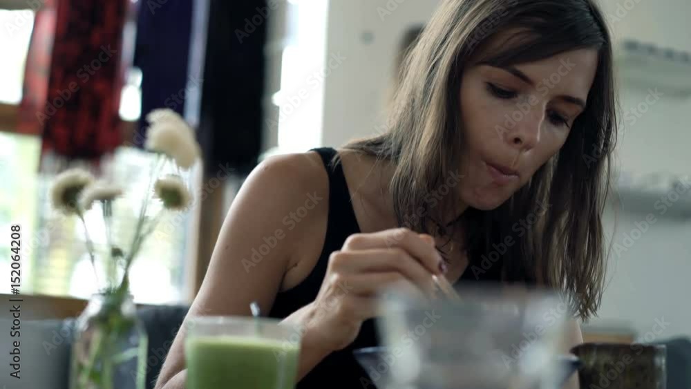 Young, pretty woman eating soup sitting in cafe in city
Young, pretty woman eating soup sitting in cafe in city