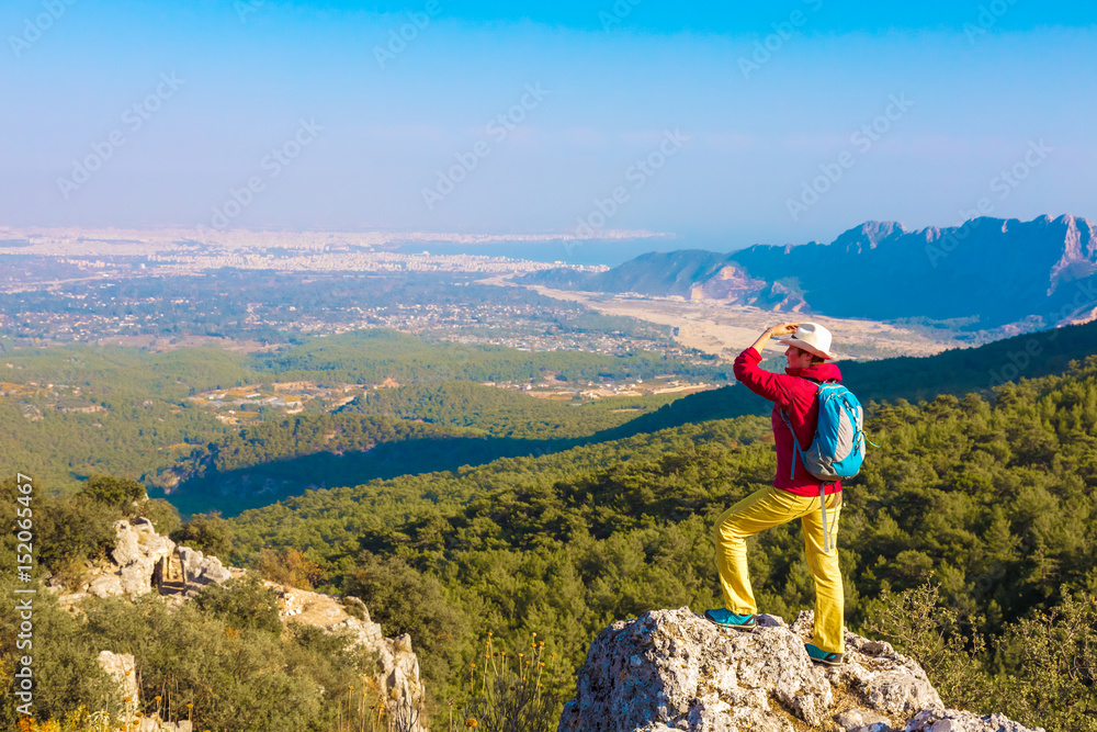 Person staying on rocky Cliff and overlooking Scenery