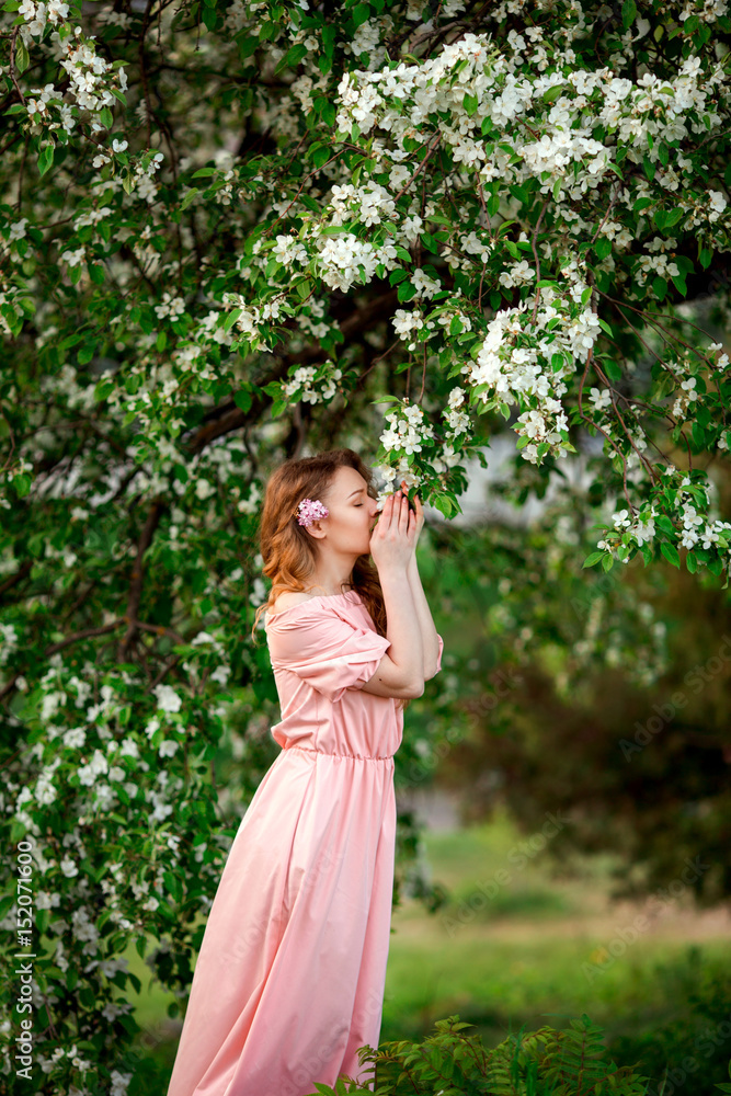 Beautiful girl in the blossoming spring tree Beautiful girl in the blossoming spring tree