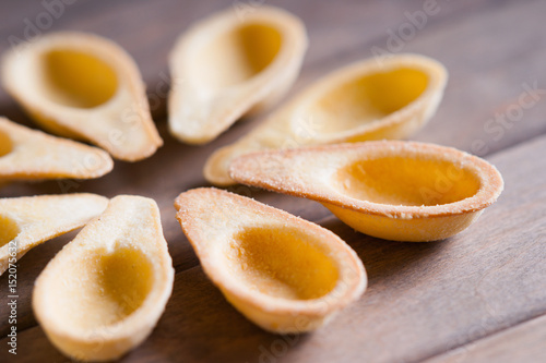 Photography of a empty tartlets on a wooden background 