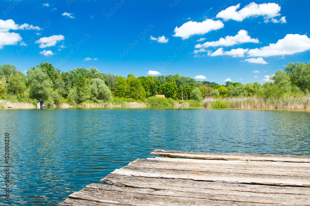 Beautiful landscape scenery – old wooden dock on lake in nature park Lonjsko polje, Croatia