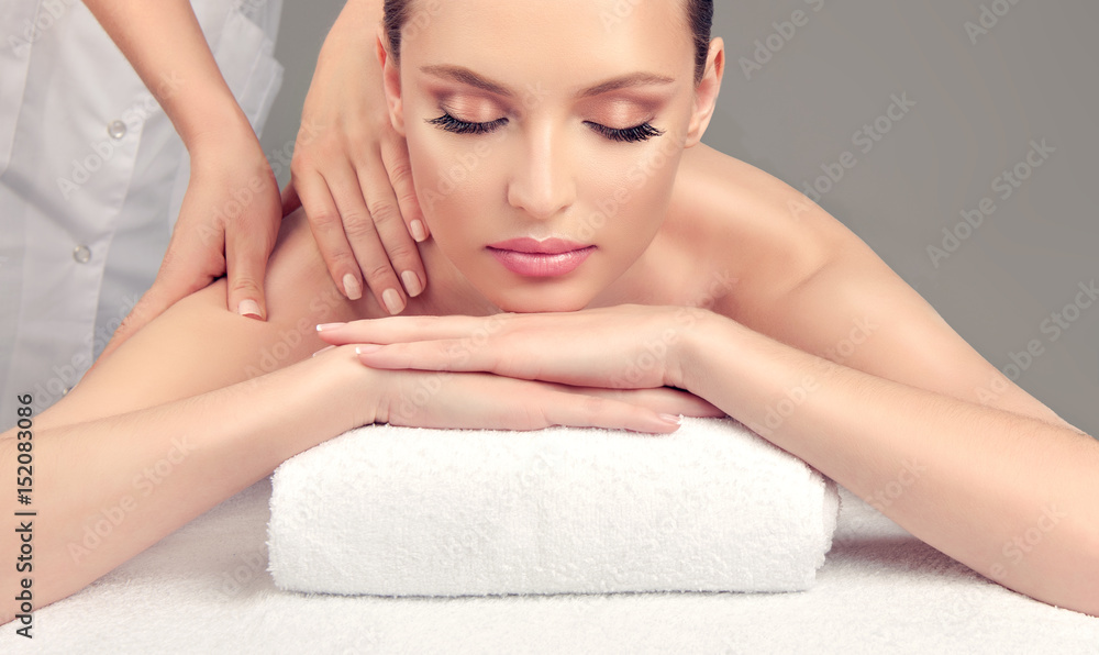Body care. Spa body massage treatment. Woman having massage in the spa salon
Body care. Spa body massage treatment. Woman having massage in the spa salon