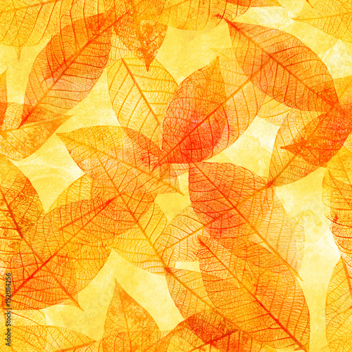 Seamless background pattern of golden tinted skeleton leaves