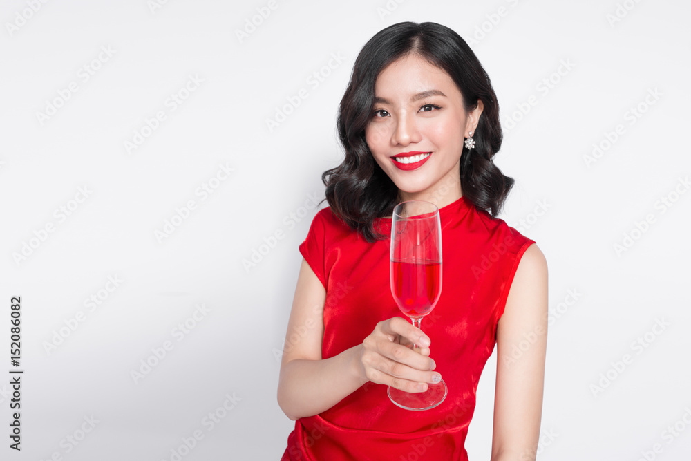 Beautiful asian girl in evening dress smiling holding glass of champagne Beautiful asian girl in evening dress smiling holding glass of champagne