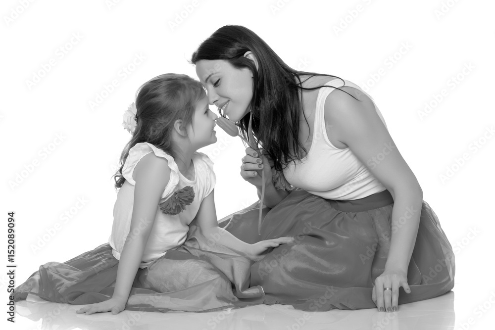 Mom and daughter with a flower of tulip. Mom and daughter with a flower of tulip.