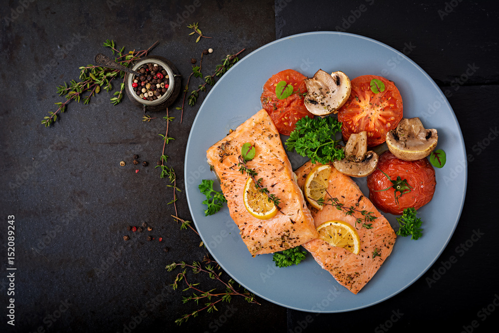 Baked salmon fish fillet with tomatoes, mushrooms and spices. Diet menu.