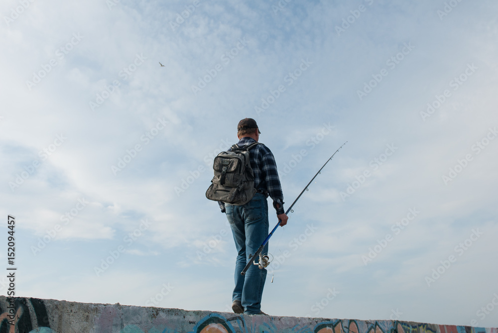 human with a fishing rod and a backpack goes fishing human with a fishing rod and a backpack goes fishing