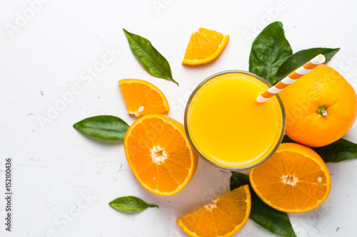 Orange juice in glass on white.