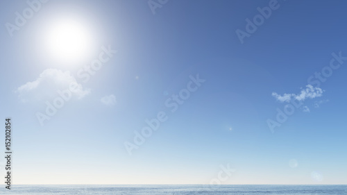 clear blue sky and sun above calm ocean water