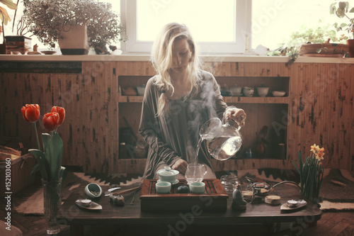 young beautiful blonde woman making tea ceremony