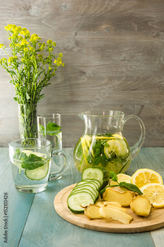 Summer drink. Ginger lemonade and ingredients - ginger, lemon, lime, mint