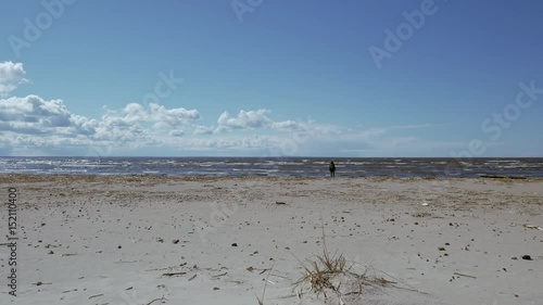 Lonely cold sunny seascape of Baltic sea in spring. View of the sea in Sosnovy Bor near Leningrad NPP. Leningradskaya oblast.  photo