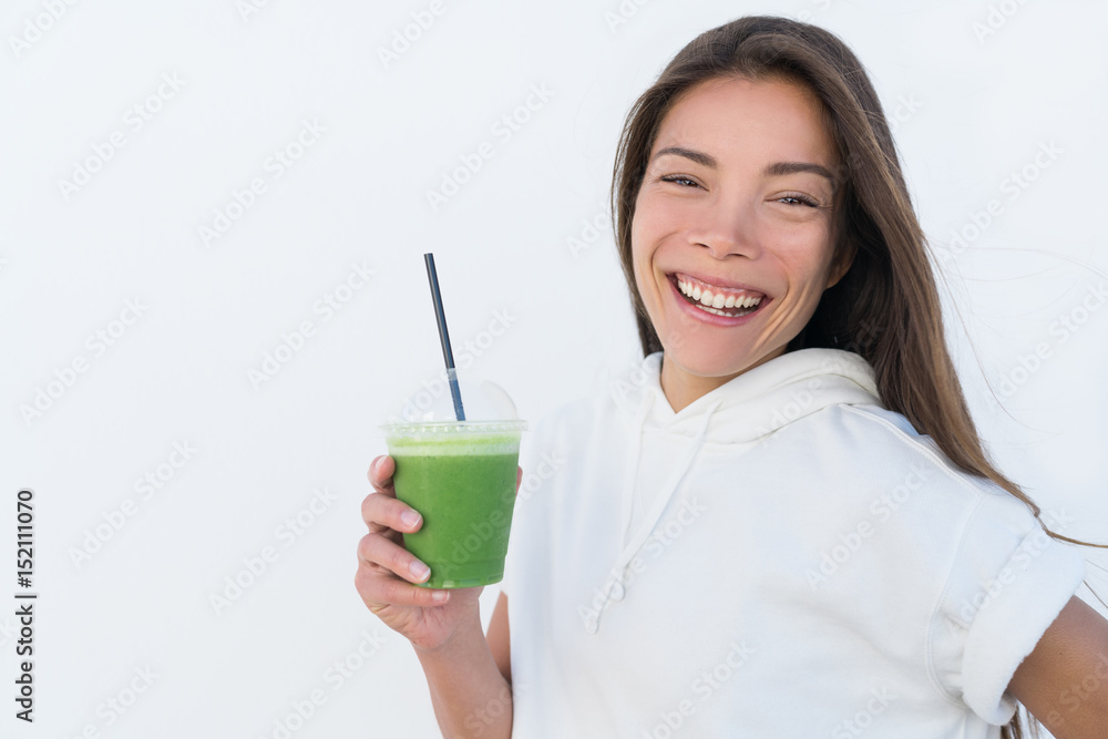 Happy Asian woman drinking healthy green spinach smoothie cup detox for weight loss diet. Young smiling fitness sporty girl with vegetable juice drink from juicing bar health trend, white background. Happy Asian woman drinking healthy green spinach smoothie cup detox for weight loss diet. Young smiling fitness sporty girl with vegetable juice drink from juicing bar health trend, white background.