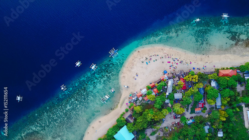 Aerial view of sandy beach with tourists swimming in beautiful clear sea water of the Sumilon island beach landing near Oslob, Cebu, Philippines. - Boost up color Processing.