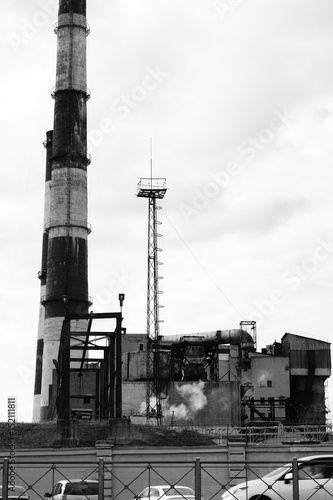 The factory in the industrial zone  two tall chimneys  black and white