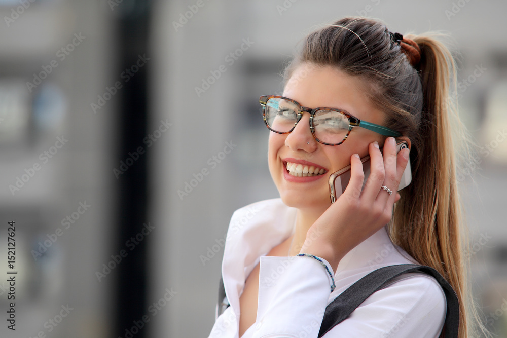 Businesswoman with a phone in a city Businesswoman with a phone in a city