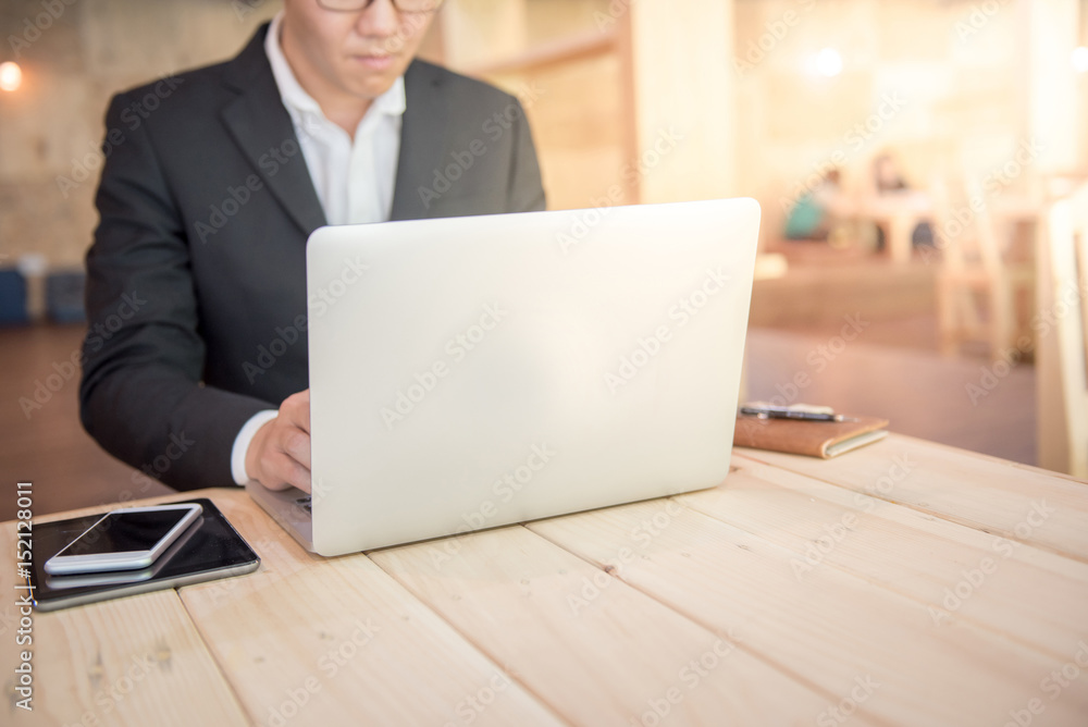 young businessman in black suit working with laptop for project management, work smart and good potential administration concepts