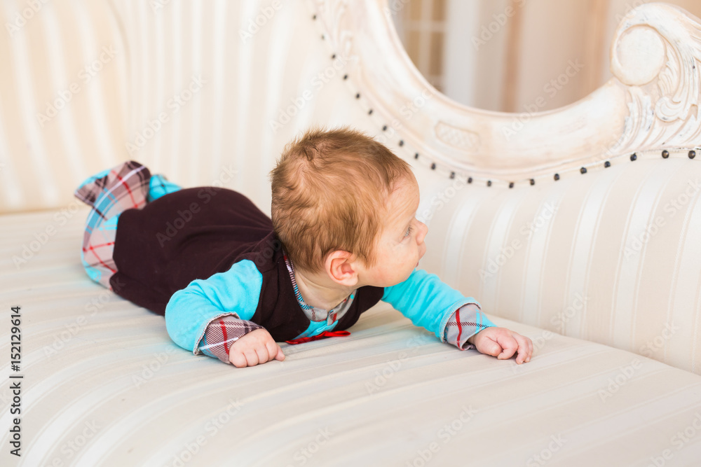 adorable baby boy lying on tummy adorable baby boy lying on tummy
