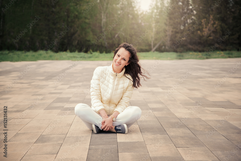 The girl is sitting on the street tile The girl is sitting on the street tile