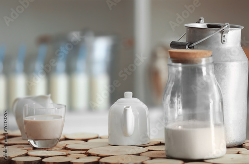 Teapot with watering can and bank on wooden stand