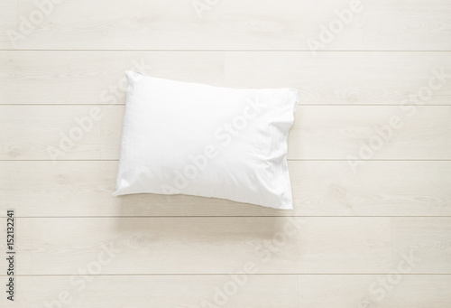 white clean pillow on the wooden floor background