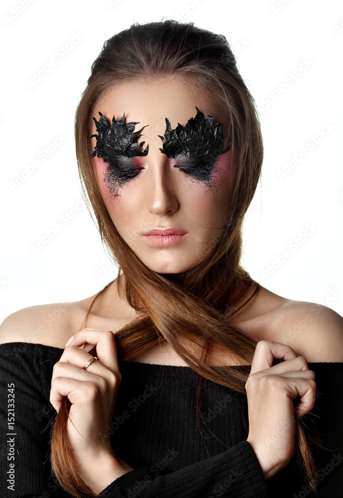 Fototapeta premium Girl close eyes with paper zigzag make-up and brown hair.Crossed hair.Creative makeup.Red background