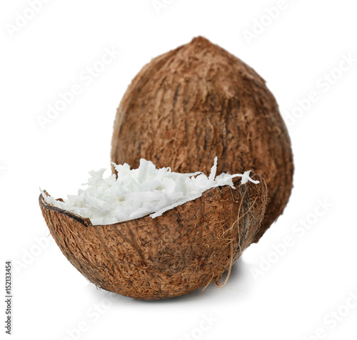 Grated coconut in shell and whole nut on white background