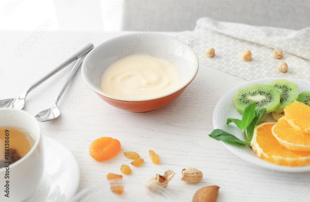 Composition with tasty yogurt on kitchen table Composition with tasty yogurt on kitchen table