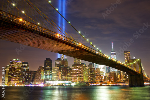 Brooklyn Bridge and Manhattan skyline with light beams © Oleksandr Dibrova