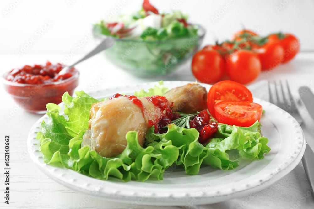 Portion of chicken and cranberry sauce on plate Portion of chicken and cranberry sauce on plate