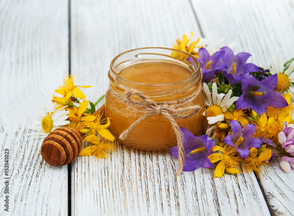 Jar of honey with wildflowers Jar of honey with wildflowers