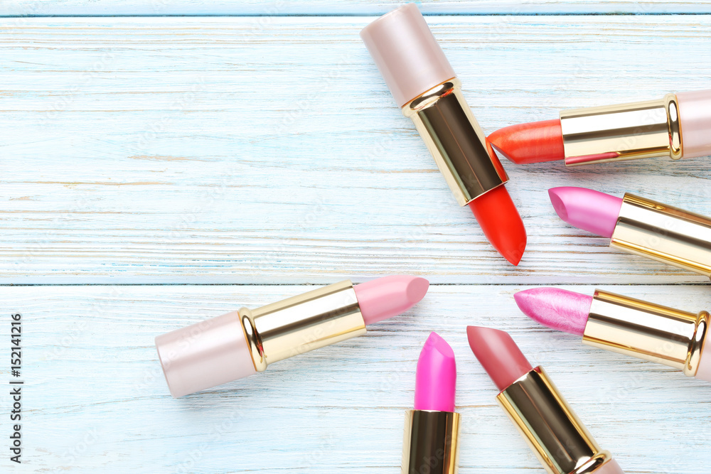 Colorful lipsticks on blue wooden table Colorful lipsticks on blue wooden table