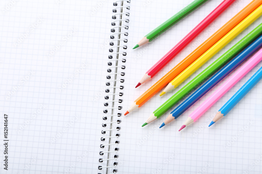 Fototapeta premium Drawing colourful pencils with blank notebook