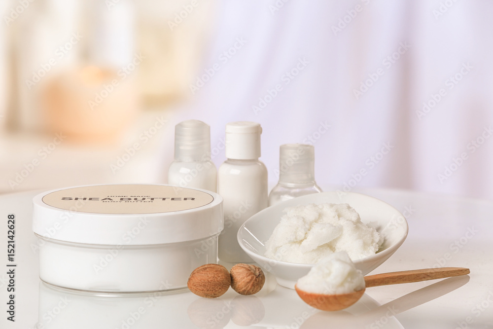 Composition of Shea butter with cosmetic products on table Composition of Shea butter with cosmetic products on table