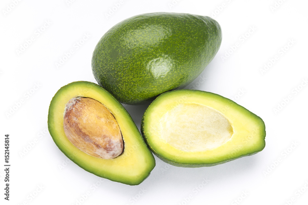 Whole and cut avocado with a bone isolated on white background. Whole and cut avocado with a bone isolated on white background.