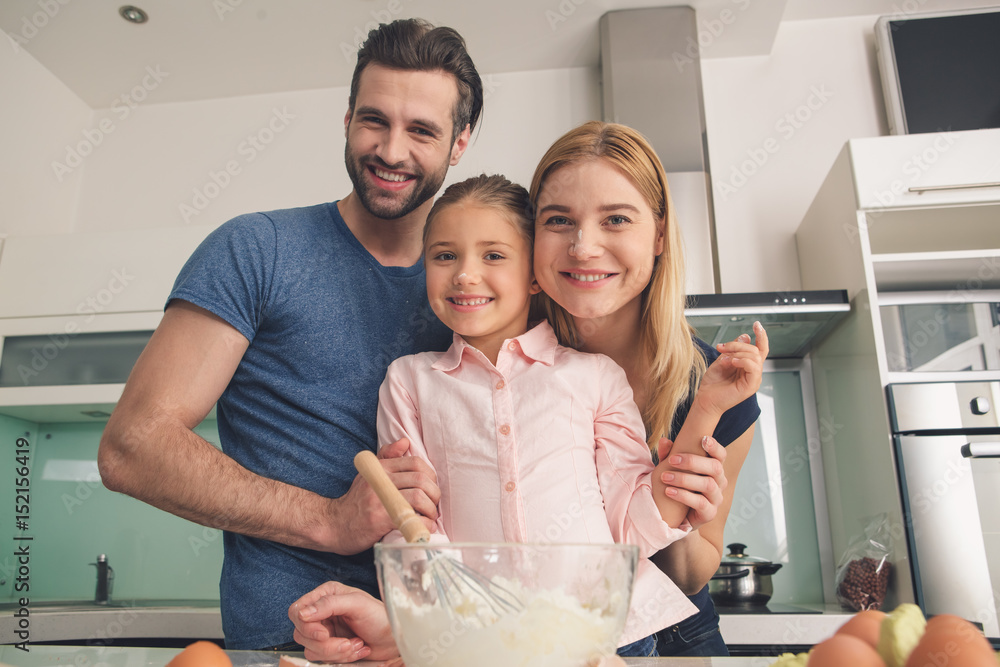 Young happy family cooking dough together mixing Young happy family cooking dough together mixing