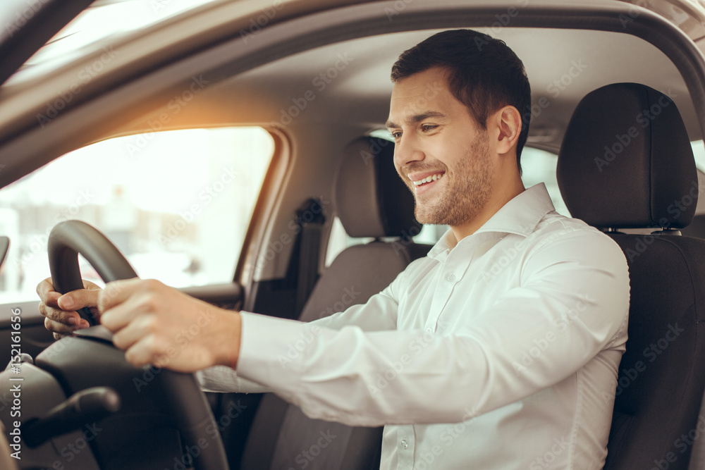 Young Man in a Car Rental Service Test Drive Concept Young Man in a Car Rental Service Test Drive Concept