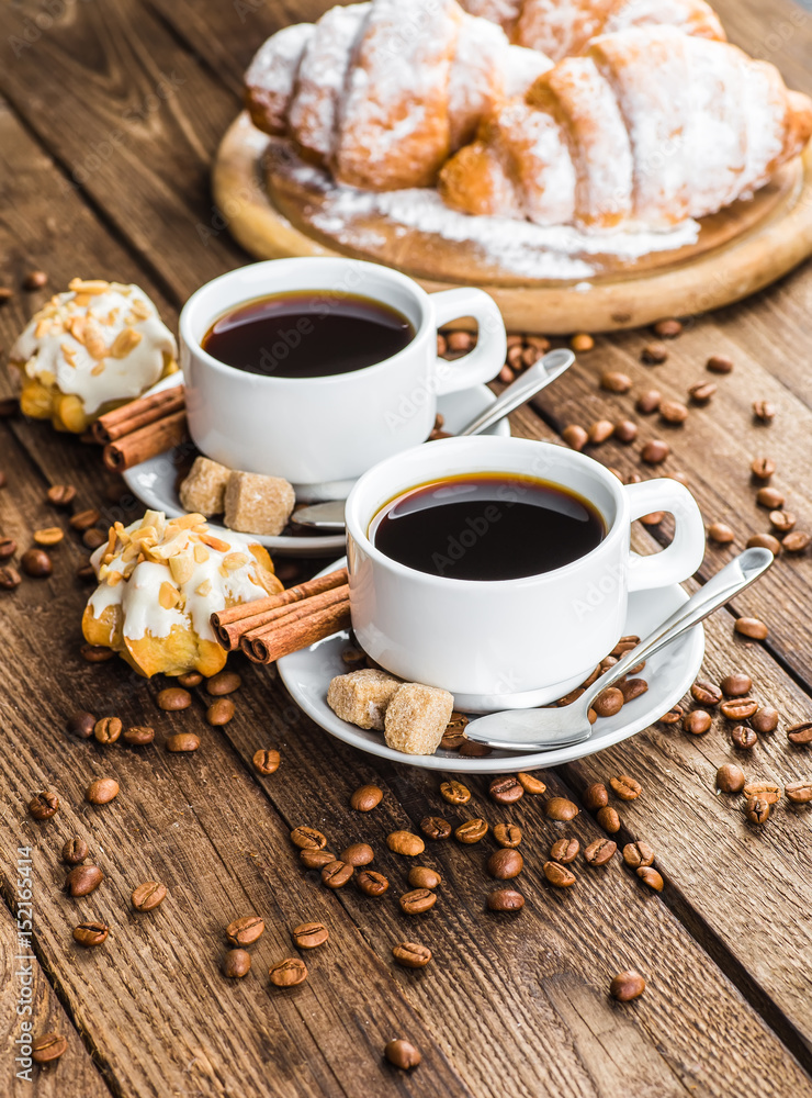 Breakfast with coffee and croissants on table Breakfast with coffee and croissants on table