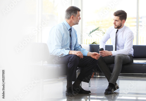 Two business colleagues at meeting in modern office interior.