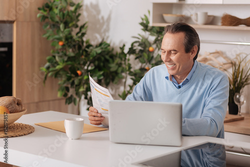 Cheerful aged man enjoying morning at home