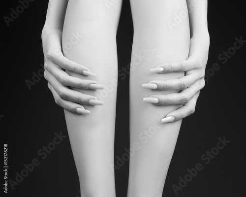 Sexy female legs on a grey background