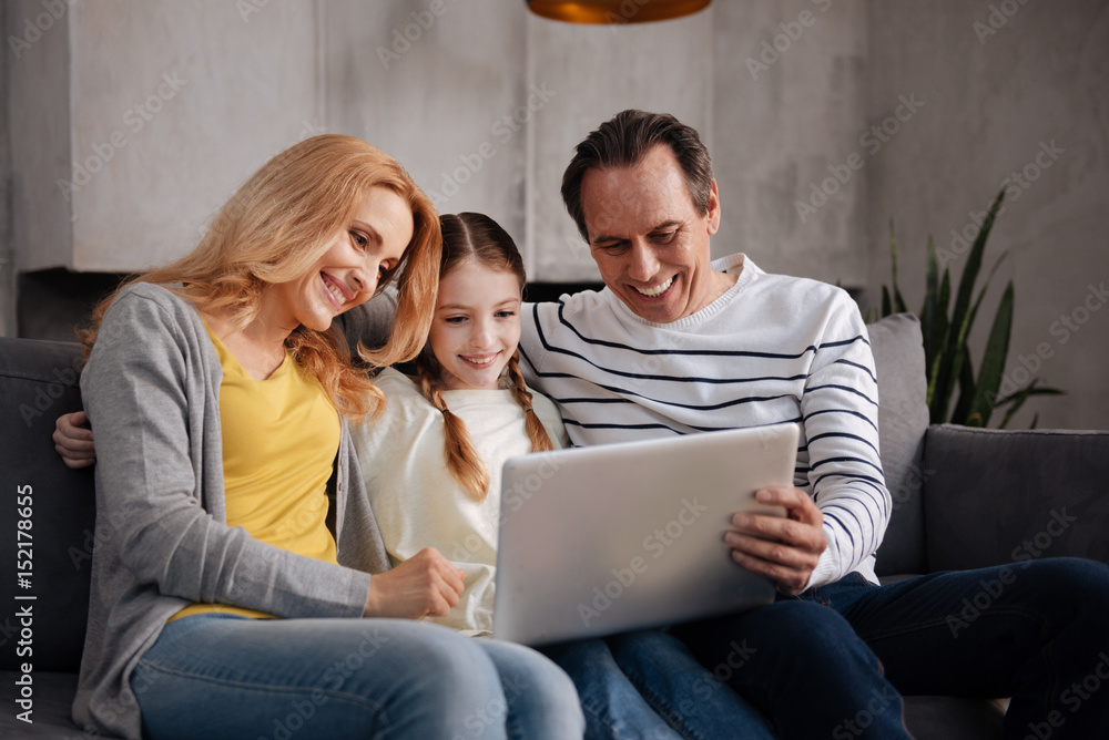 Positive family using electronic gadget at home