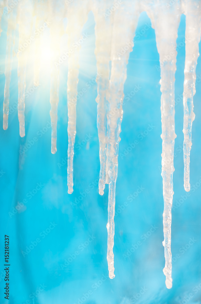 Frozen icicles in clear sunny against the blue sky Frozen icicles in clear sunny against the blue sky